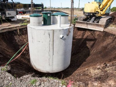 Environmentally friendly septic tank being lowered into ground.