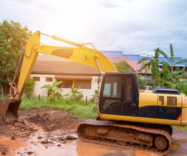 Repair of roads damaged in the rains with car backhoe .
